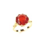 Yellow gold fire opal ring, tests 18 ct. The circular cut fire opal weighing approx. 3.