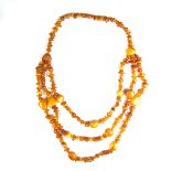 Three strand amber bead necklace. Length 605 mm / 23.75 in. Weight 83 grams.