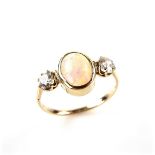 Yellow gold opal and diamond ring, tests 18 ct. The oval opal cabochon weighing approx. 1.