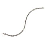 White gold diamond tennis bracelet, tests 18 ct. Set with fifty-six princess cut diamonds.