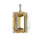 18 ct yellow and white gold diamond and citrine pendant. The emerald cut citrine weighing approx.