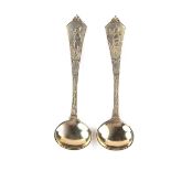 A pair of Chinese sterling silver gilt salt spoons, 20th century. 3.6 in (9.1 cm) length.