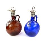 A pair of Victorian engraved Bristol blue and brown glass decanters.