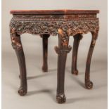 A Chinese Carved Elm Six-Side Center Table, 20th Century. Dimensions: h: 33 x w: 39 x d: 39 in.