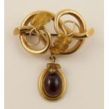 A late Victorian brooch in the shape of a lovers knot, with attached locket back pendant set with