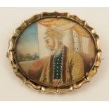 An Islamic miniature of a gentleman in an interior looking out onto a garden. Approx dimensions 42mm