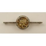 A large citrine and diamond bar brooch length approx 60mm the round facet cut mid yellow citrine