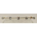 An old cut diamond bar brooch set in yellow and white metal, the five old cut diamonds of