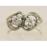 A 14ct twin stone diamond ring in Art Nouveau style mount, diamond combined total approx 0.70cts.