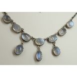 An Arts & Crafts moonstone necklet set with ten high cabouchon moonstones in cut back claw settings,