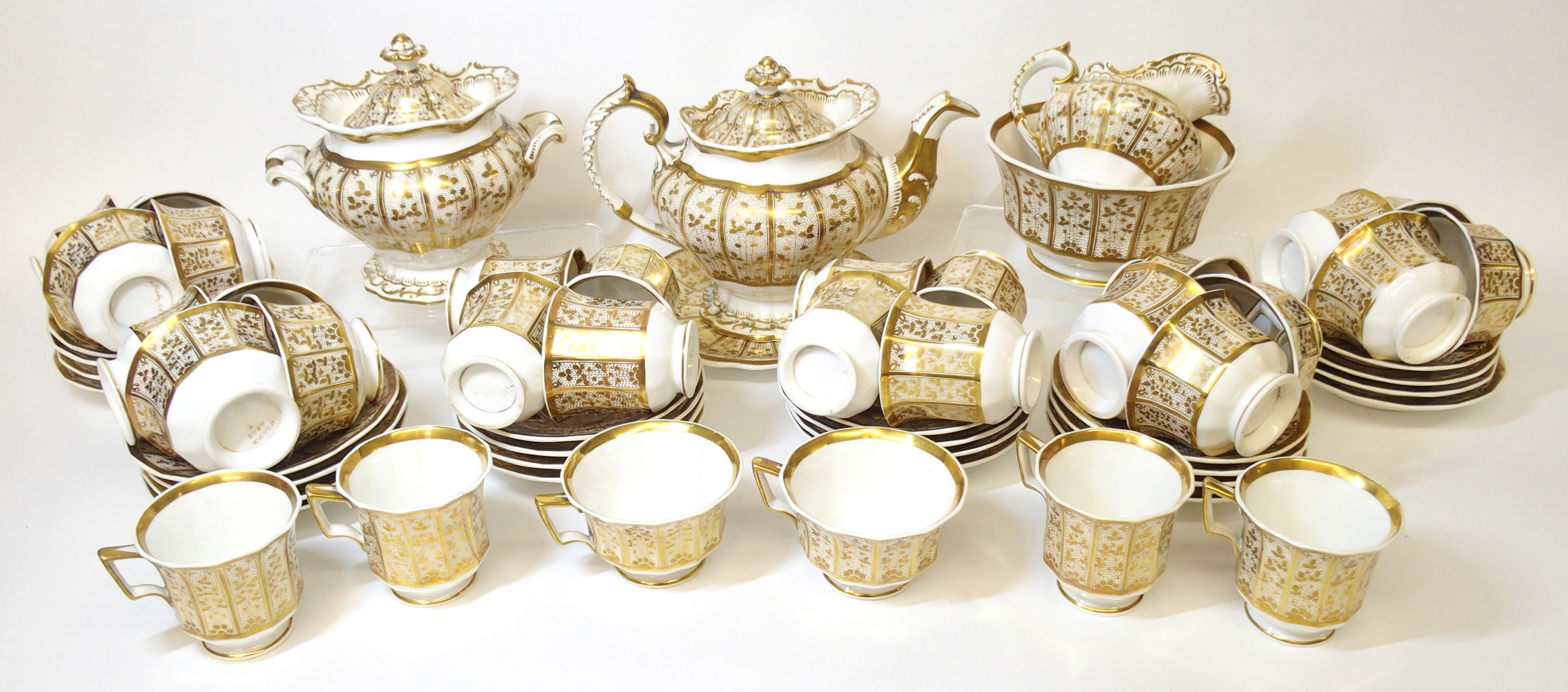 A Spode porcelain tea service, 19th Century gilt stylized vines to white ground, comprising; a