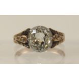 An old cut diamond ring of approx 1.05cts in cut back claw setting, the shoulders and shank in