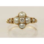 An Edwardian pearl and diamond ring set in unhallmarked yellow metal, the quatrefoil shape had an