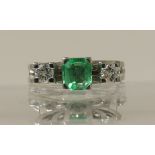 A retro emerald and diamond ring in white metal with unknown hallmarks diamond combined total approx