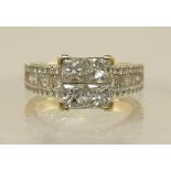 An 18ct princess cut diamond ring the central panel of four princess cut diamonds, with further