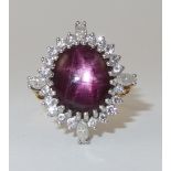 A substantial 18ct gold star ruby and diamond ring the ruby of a deep reddish purple displays a