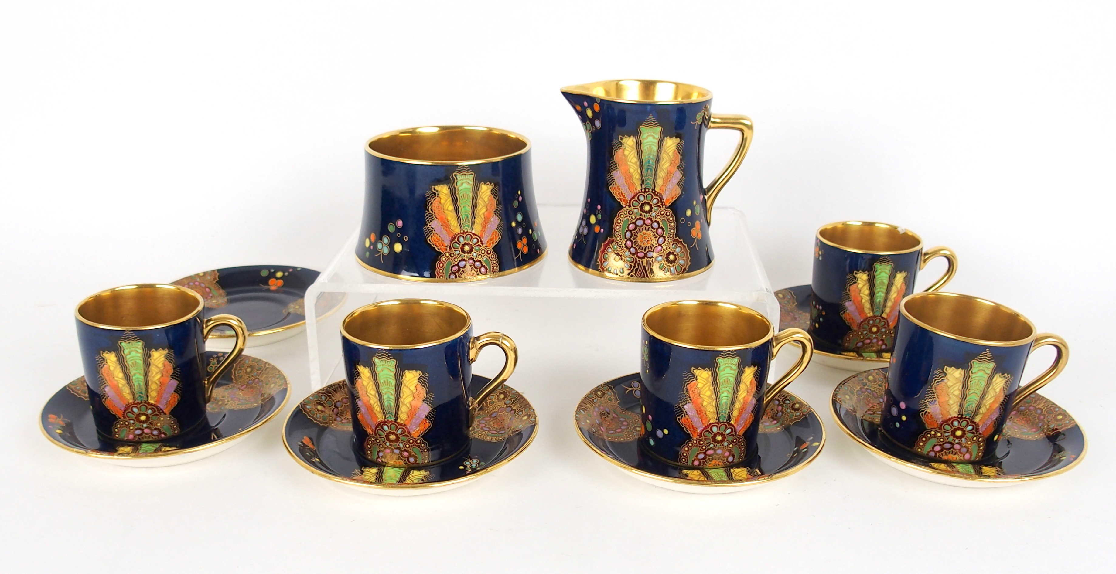 A Carlton Ware Art Deco coffee set painted with fan shaped panels and scattered flowers