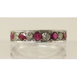 An 18ct white gold ruby and diamond half eternity ring