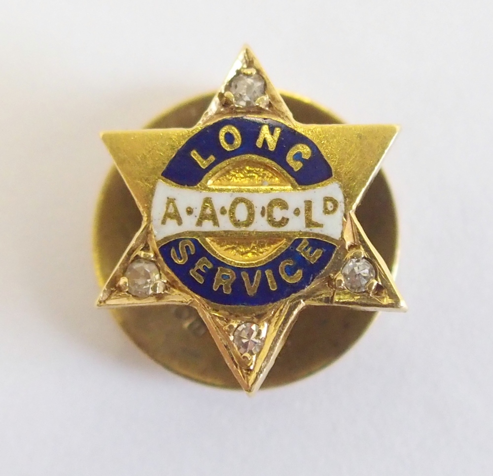 An 18ct gold long service tie stud for the Anglo-American Oil Co set with diamonds to four points of