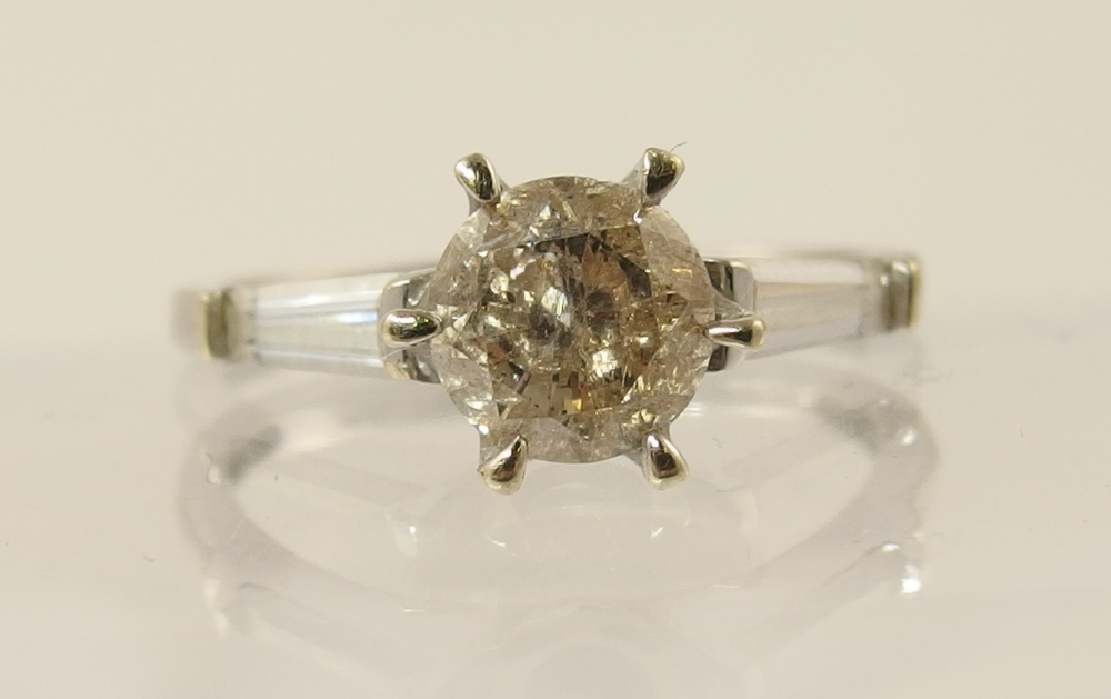 A 9ct champagne diamond ring with gem set shoulders