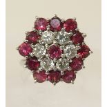 A ruby and diamond flower cluster ring. Diamond combined total approx 0.60cts