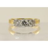 An 18ct three stone diamond ring, combined total approx 1.07cts