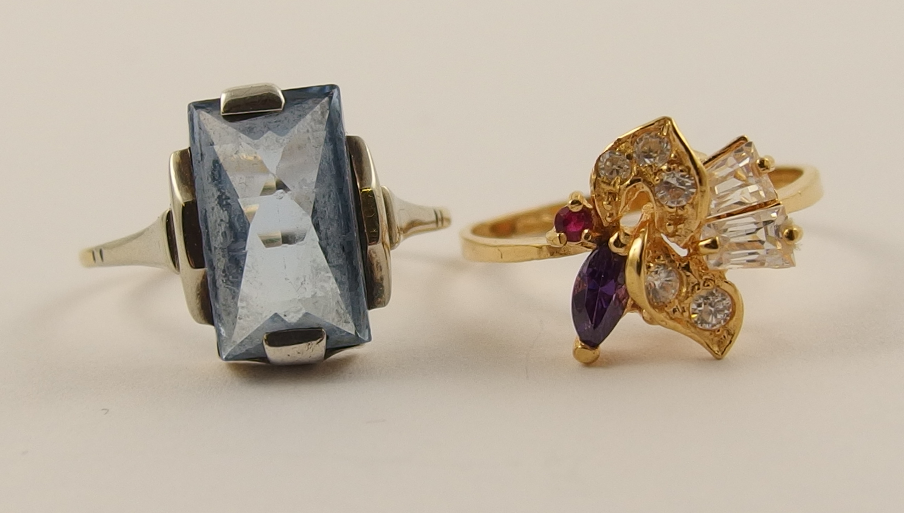 A lot comprising of an Art Deco 9ct white gold ring set with a fancy cut blue gem stone and a yellow