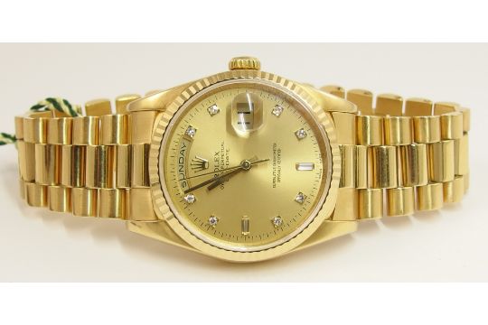 18ct Oyster perpetual Day-Date the gold champagne coloured dial is Rolex Oy