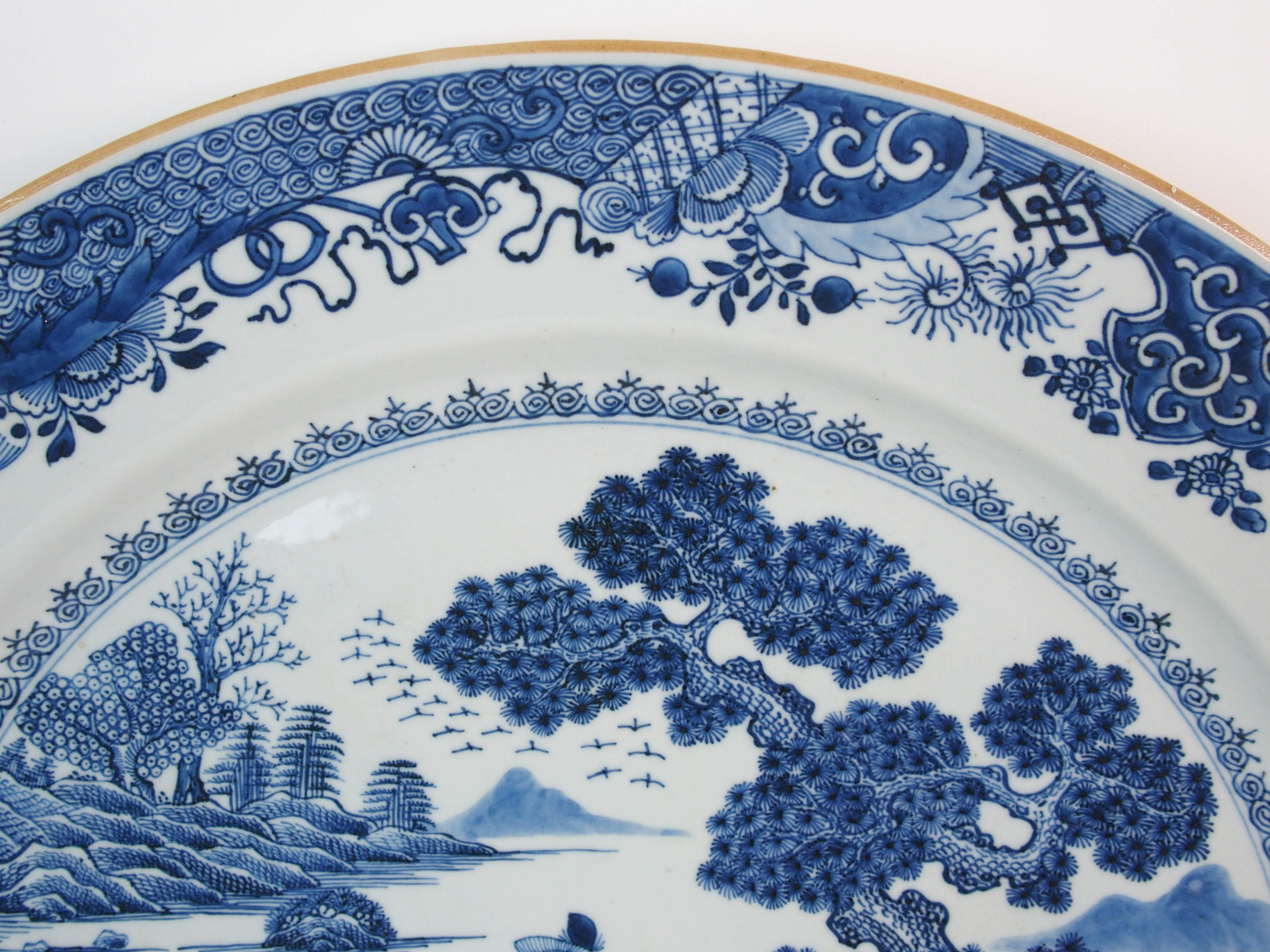 A Chinese blue and white charger painted with a man standing on an island beneath a pine tree - Image 3 of 10