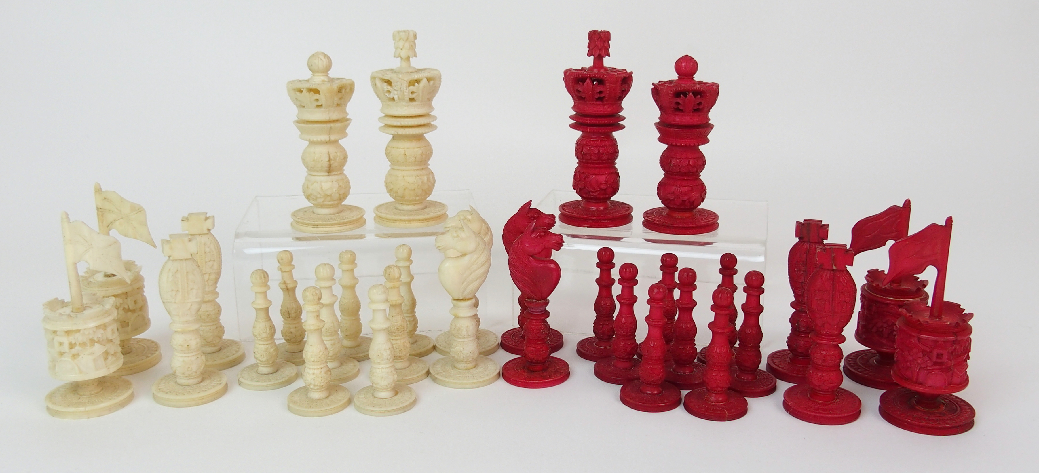 A Cantonese ivory chess set the King and Queen carved with pierced crown above double baluster