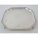 A silver salver by Fenton Brothers Limited, Sheffield 1931 of square form with stepped rim and