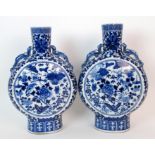 A pair of Chinese blue and white pilgrim bottle shaped vases painted with birds and insects