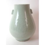 A Chinese celadon archers vase carved with two roundels of phoenix beneath a key pattern band and