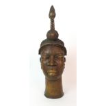 A Benin female brass head with high tied hair ornament with scarafied face, 52cm high