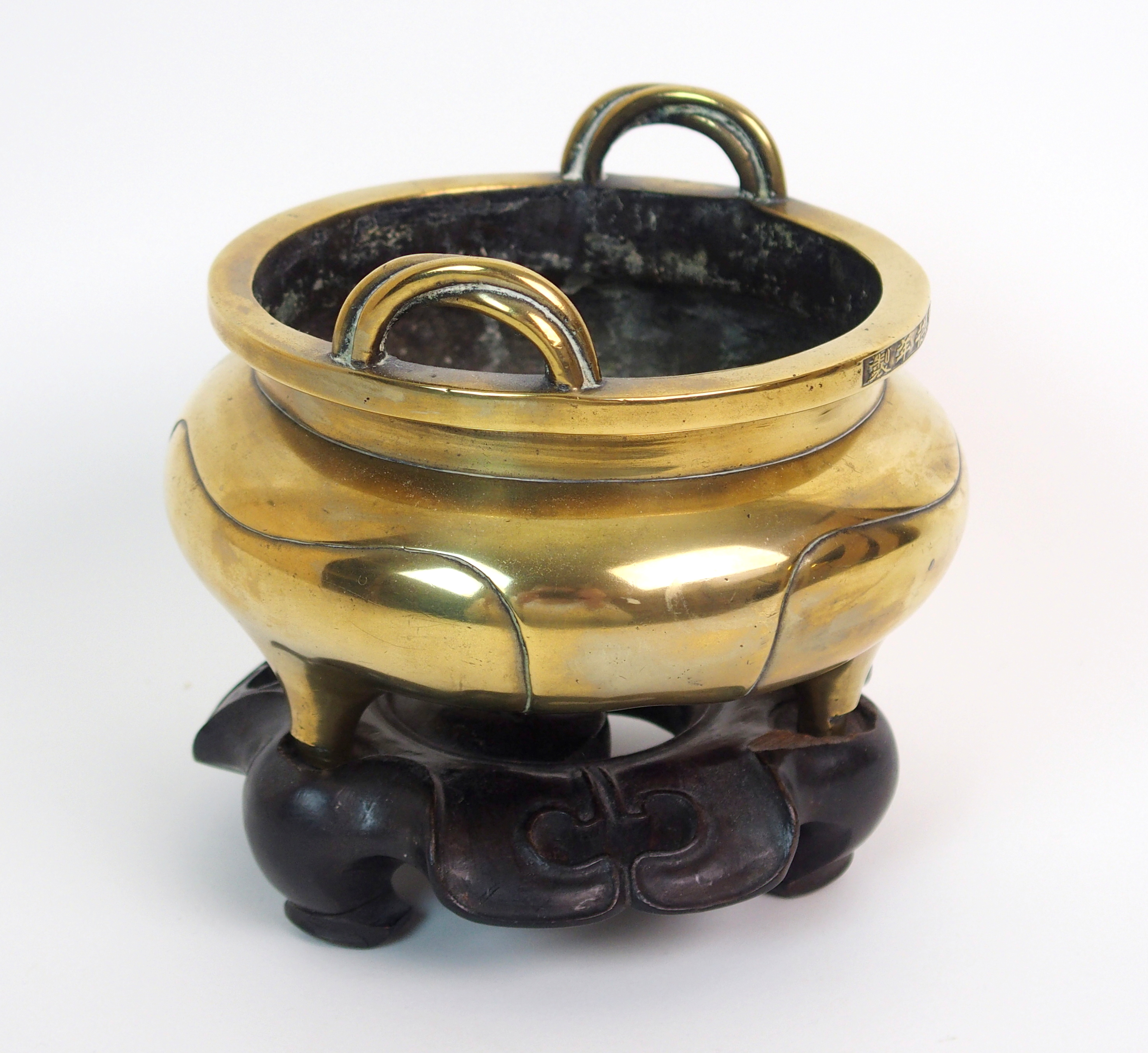 A Chinese brass tripod censor with entwineded handles to flat rim above six character reign mark and - Image 2 of 10