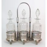 A silver plated 3-bottle decanter stand with pierced decoration, on six outswept feet and looping