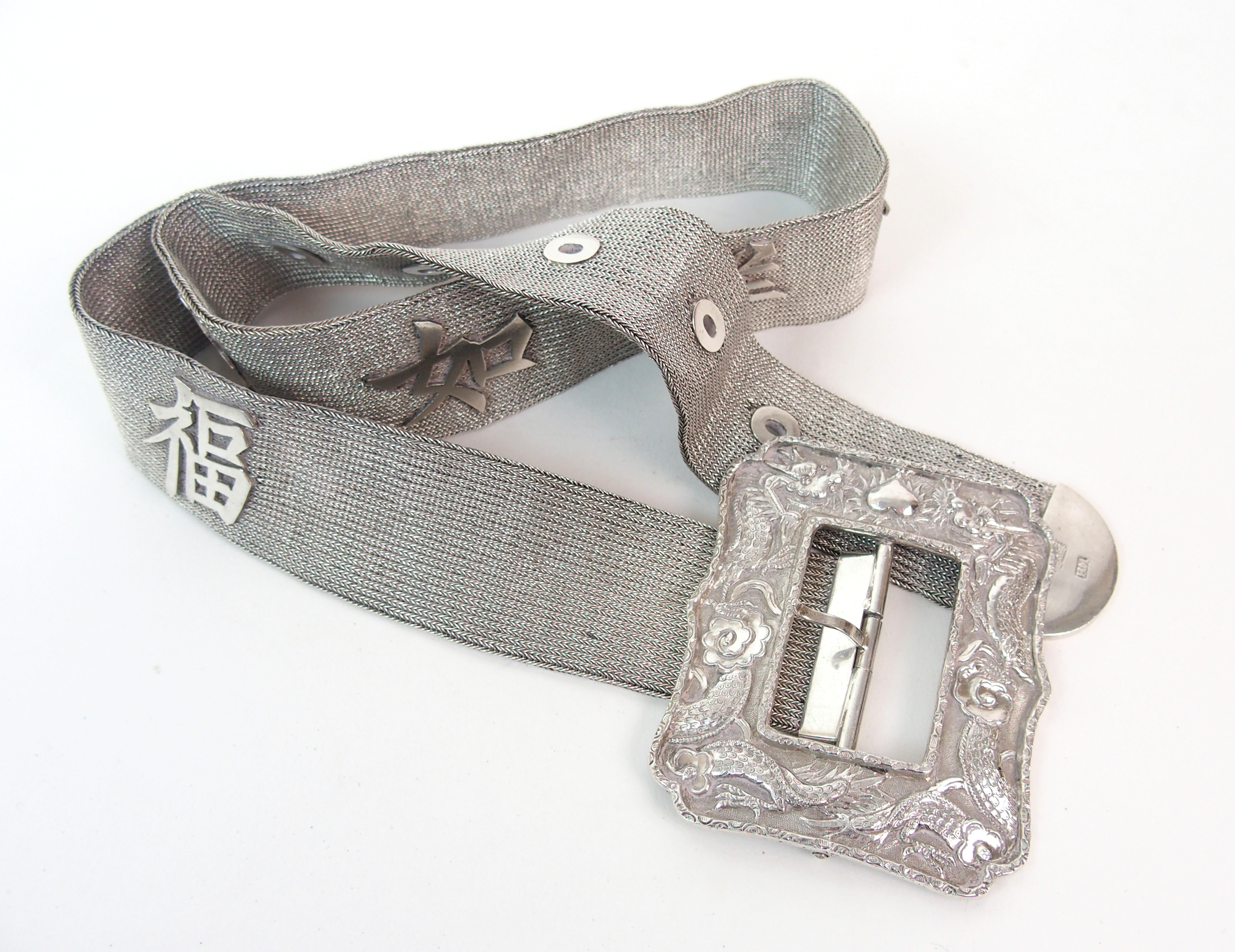 A Chinese silver mesh belt applied with shou characters, the buckle cast with dragons chasing the