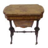 A Victorian walnut inlaid games and sewing table on carved scroll legs joined by a stretcher, 69cm