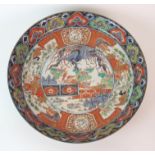 An Imari dish painted with central roundel of Ho-o birds in a fenced garden within bands of