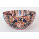 An Imari fluted fruit bowl painted with medallions of figures divided by diaper and foliate