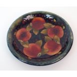 A Moorcroft Pottery "Pomegranate" dish pomegranates to centre on blue ground, marked "Moorcroft"