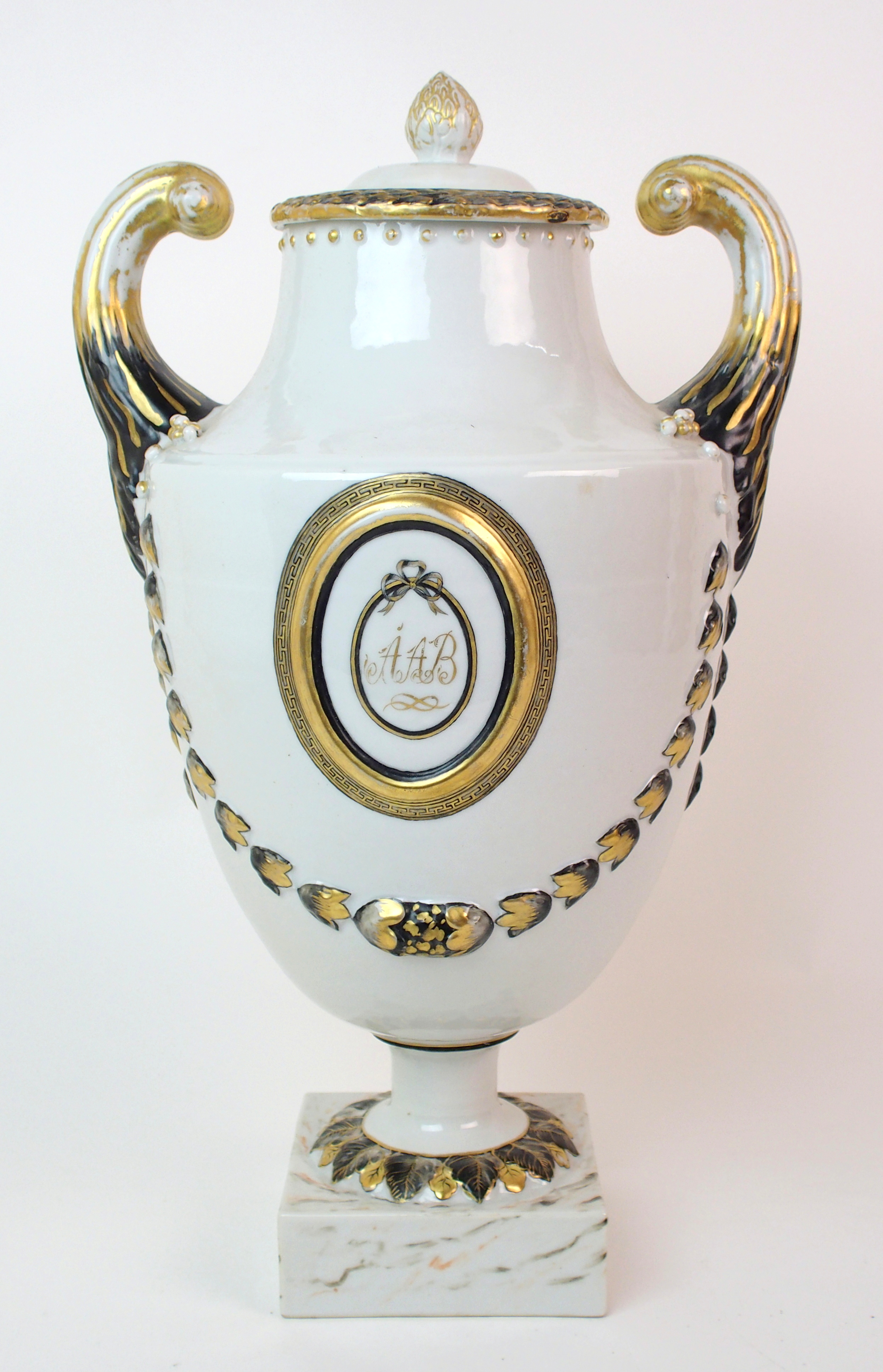 A Chinese export Neo classical two-handled urn and cover with bud finial laurel wreath, scroll