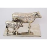 A silver animal figure group by Elkington & Co, Birmingham 1914, modelled as a cow and calf on plain