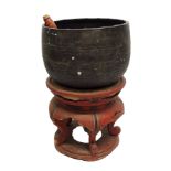 A Chinese hardwood copper drum gong on a red lacquered scroll shape base, 67cm high