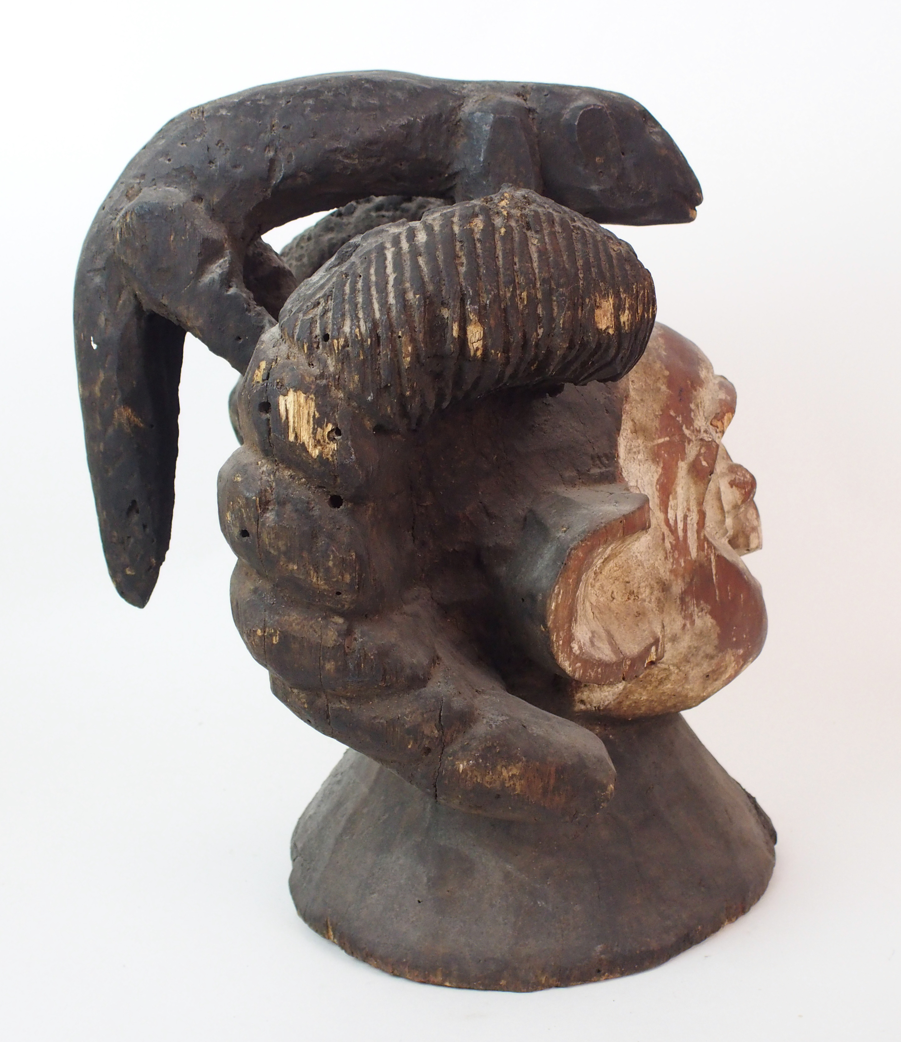 An African carved and painted wood mask with animal finial and scroll shaped ears, 38cm high - Image 3 of 10