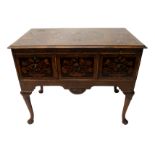 An English marquetry and walnut dressing table the top with an oval foliate panel flanked by six