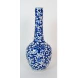 A Chinese blue and white bottle shaped vase painted with peonies and scrolling foliage, blue