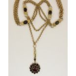 A 9ct decorative chain set at intervals with garnets with a garnet set flower pendant, weight approx