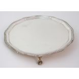 A silver salver by Roberts & Belk, Sheffield 1957, of circular form with stepped, scalloped and