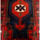 A Hamadan runner on a blue and red ground, 3.07 x 1.08m